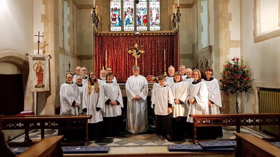 The choir of St Barnabas standing before the high altar and east window