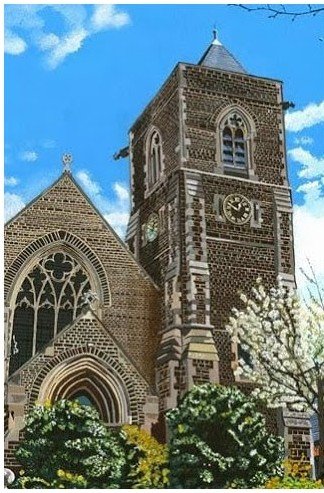 The tower and west front of St Barnabas Church in spring blossom